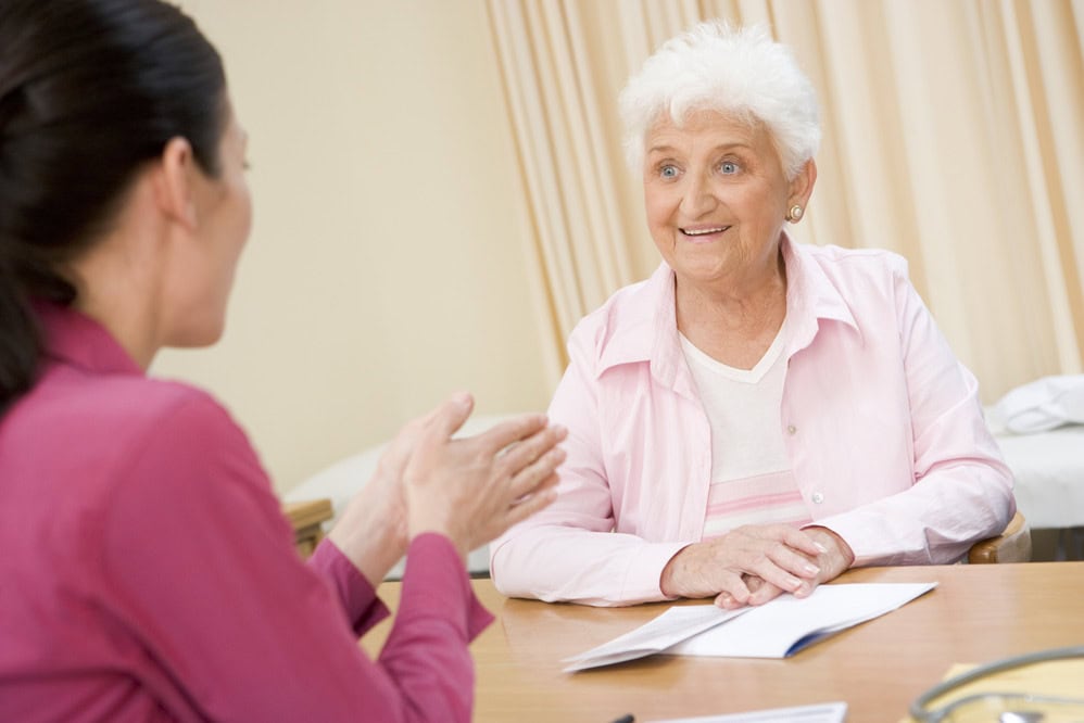 therapist helping older woman with her speech